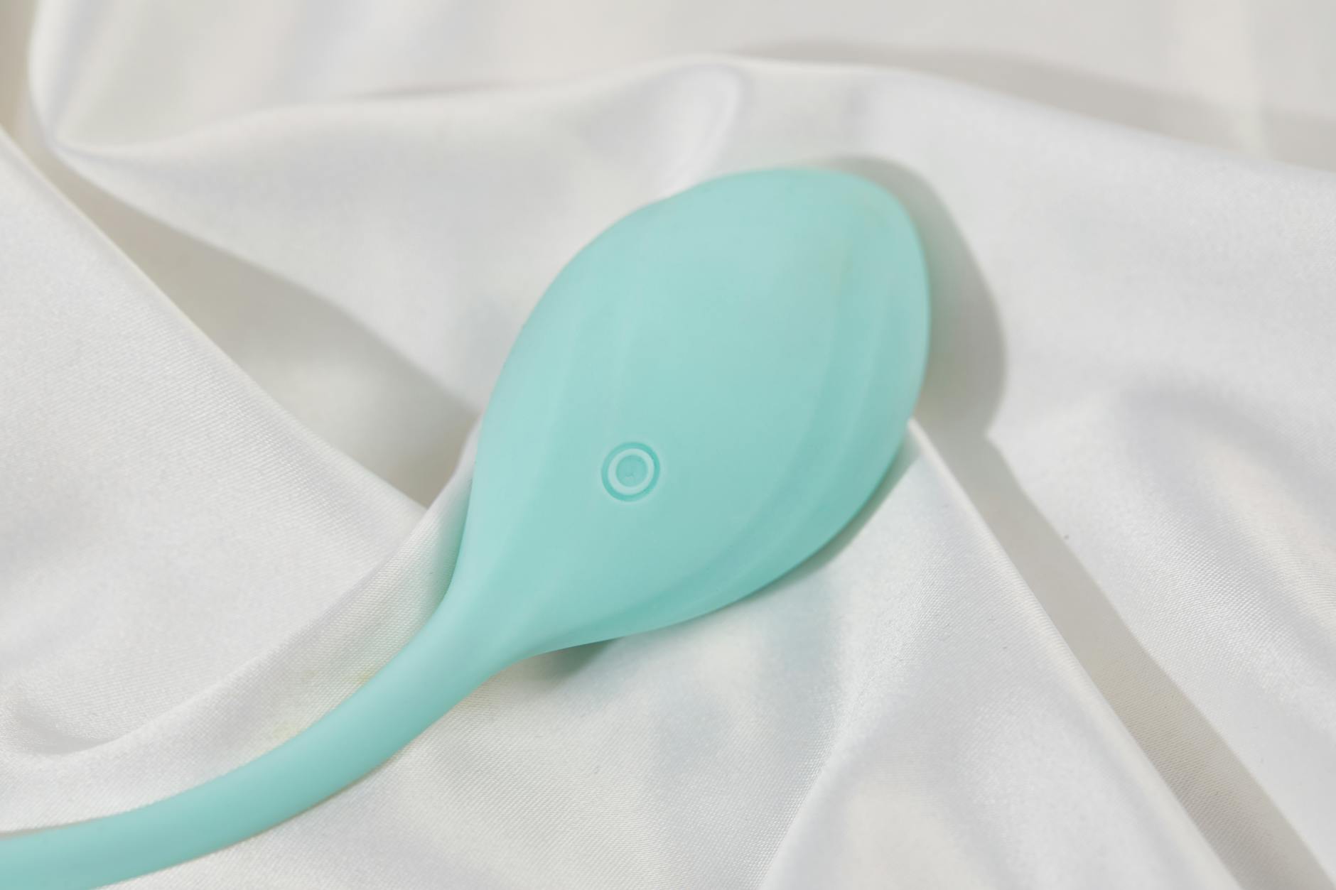 Woman contemplating her choices with two vibrators, showing thoughtful consideration of pleasure products