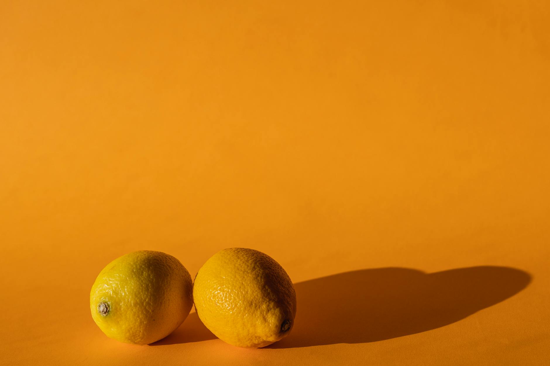 Ripe vivid lemons on bright yellow background, representing fresh approaches to pleasure after medication shifts